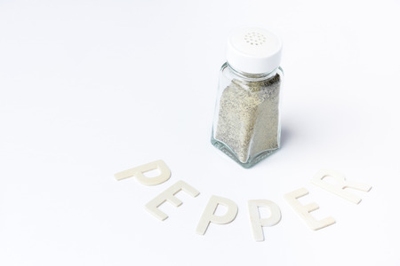 Pepper in glass container on white backgroundの写真素材