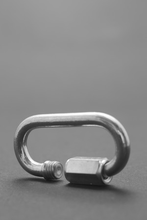 Steel screw carabiner isolated on dark backgroundの写真素材