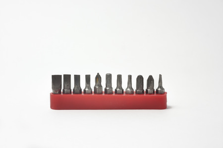 Front view of screwdriver bits in their plastic holders on white background