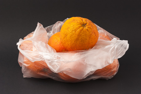 Oranges in a white envelope on a black background to understand a concept for healthy eatingの写真素材
