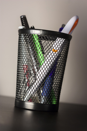 Container for black pens on an incline to understand a working concept of business relationshipsの写真素材