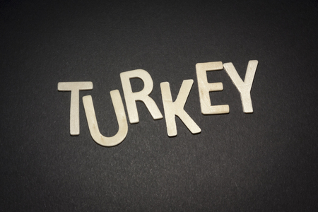 Turkey written with wooden letters on a black background to understand the concept of nutrition and advertisingの写真素材
