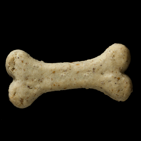 Dog biscuit on black background to connote a concept of feeding animalsの写真素材