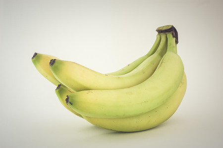 Banana honey over white background concept of a healthy eating conceptの写真素材