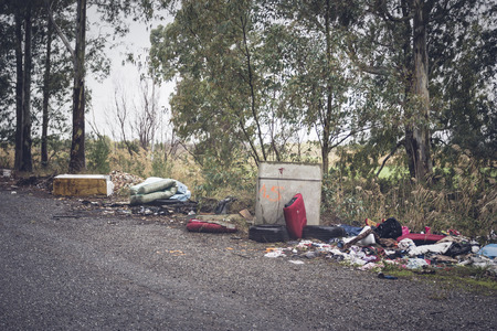 Garbage left at the side of the road to understand an environmental conceptの写真素材