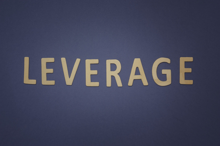 Leverage written with wooden letters on a blue background to mean a business conceptの写真素材
