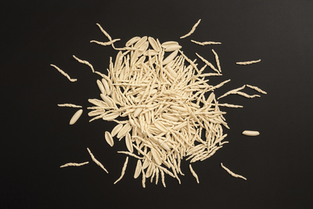 Homemade pasta on a black background to mean a concept of nutrition and businessの写真素材