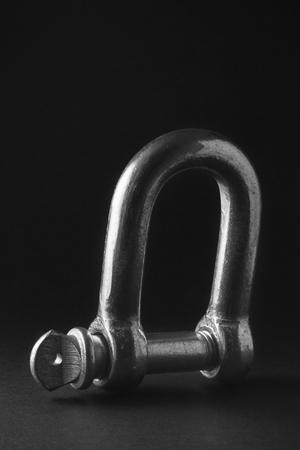 Industrial hook on a black background to mean an industrial conceptの写真素材