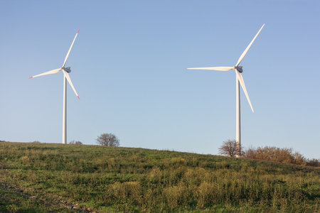 Power wind wheel with sunset in Italy. Light and shadow on the landscape. Beautiful mountain range...