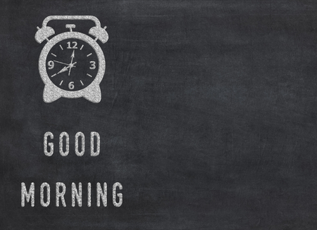 Good Morning - clock with text on black background to mean a conceptの写真素材