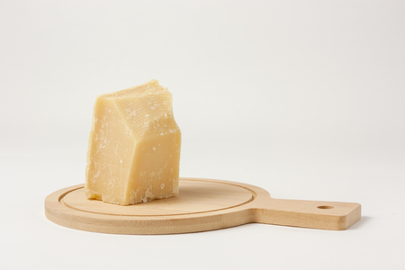 Piece of cheese isolated on white background to mean a conceptの写真素材