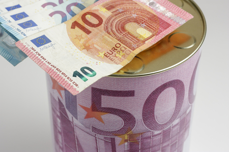 Piggy bank with ten and twenty euro banknotes, seen from above to mean a conceptの写真素材