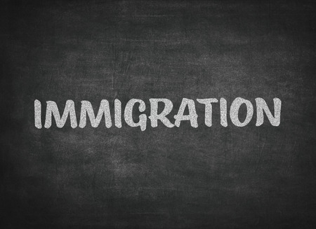 The word immigration written on a blackboardの写真素材