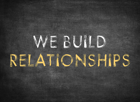 we build relationships on chalkboard backgroundの写真素材