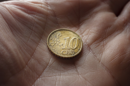 Closeup of male hand holding euro coinsの写真素材