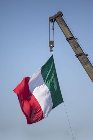 Italia flag on a mat in the wind and blue skyの写真素材