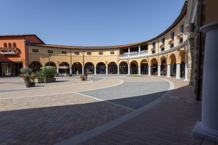 Valdichiana Outlet Village, Italy 09/17/2019: Main square of the shopping center to mean a conceptのeditorial素材