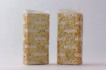 Matera, Italy - May 26, 2019: Crackers on a white background to mean a business conceptのeditorial素材