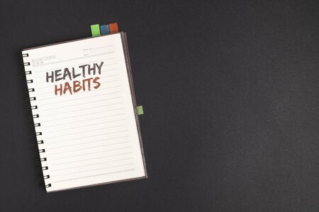 Word writing text Healthy Habits. Business concept for Good nutrition diet take care of oneself Weight Control Text two Words notes written white notepad black pen pink desk school workの写真素材