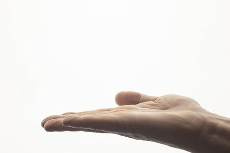 Hand gesture open up like holding something on palm isolated on white backgroundの写真素材