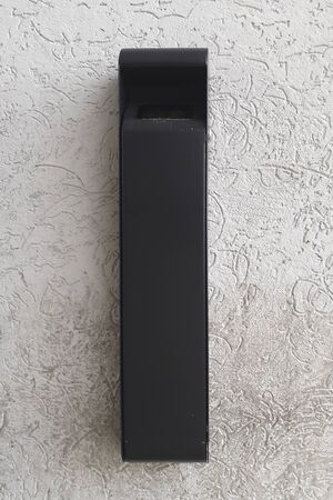 Vertical metal ashtray on a concrete wall to mean a concept