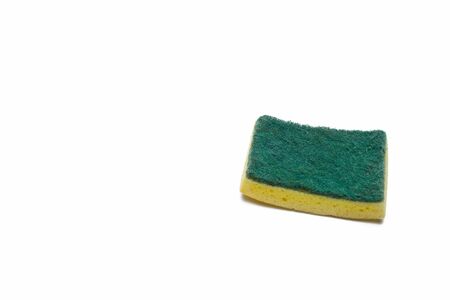Yellow sponge with green scrubber attached isolated on white backgroundの写真素材