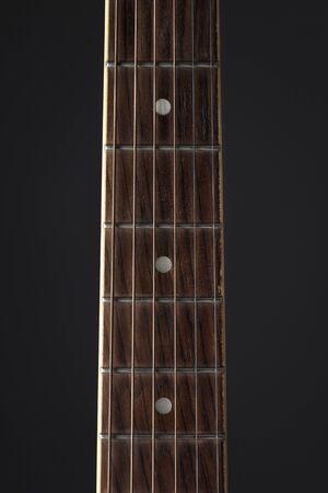 Detail of classic guitar with shallow depth of field. Closeup image of acoustic guitar fingerboard, Photography classical guitar on a light backgroundの写真素材