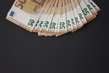 Fifty euro banknotes on a black background to mean a business conceptの写真素材