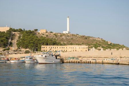 Lighthouse overlooking the bay of Santa Maria di Leuca with cityscape, ship on the ocean, clear sky.のeditorial素材