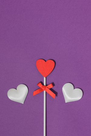 Three hearts on a purple background.の写真素材