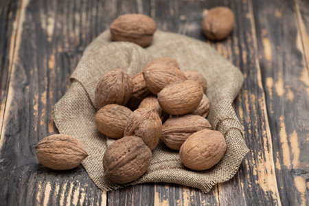 Whole walnuts on a wooden background, top viewの写真素材
