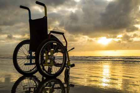 Sunset childlike wheelchair horizon sandの写真素材