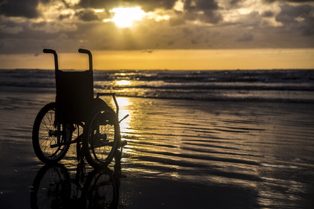 Sunset childlike wheelchair horizon sandの写真素材