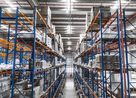 Logistic shed and distribution boxes workers and forklift in operationの写真素材