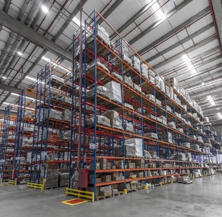 Logistic shed and distribution boxes workers and forklift in operationの写真素材