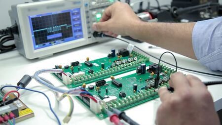 Manual electronics soldering and oscilloscope testingの写真素材
