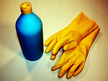 Bottle with chemical and rubber gloves for protectionの写真素材