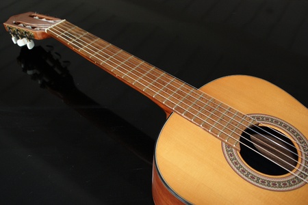 Classic wooden guitar on black backgroundの写真素材