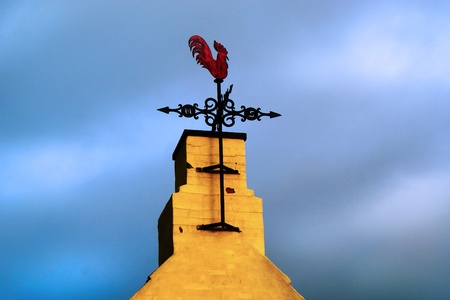 Weather vane on a stormy and cloudy skyの写真素材