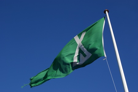Camping flag waving aginst blue skyの写真素材