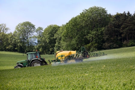 Farmer spraying his fieldのeditorial素材