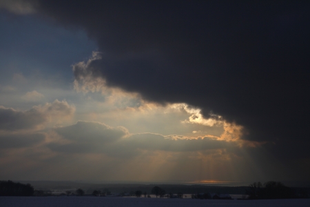 Dark clouds gives way for the sun  Beautiful winter landscape  Bornholm  Denmark の写真素材