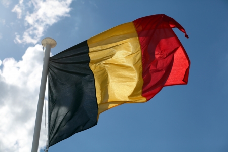 The German flag against sunny sky.の写真素材
