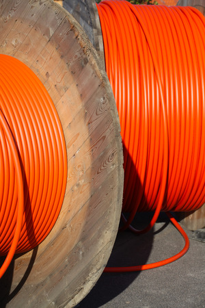 Huge orange cable drums for optic fibre connections.の写真素材