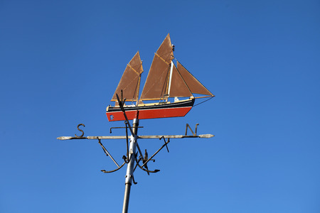 Ship weather vane pointing north.