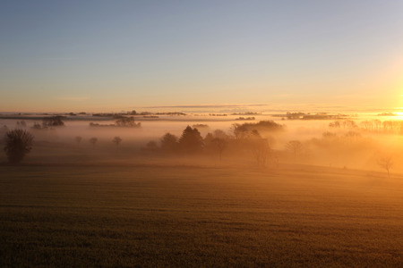 Scandinavian countryside landscape in morning mistの写真素材