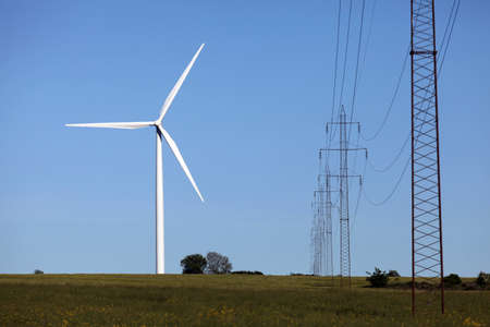A wind turbine and high voltage power lineの写真素材
