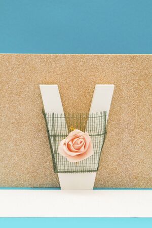 Letter objects with flowers, roses and decorations on a blue backgroundの写真素材