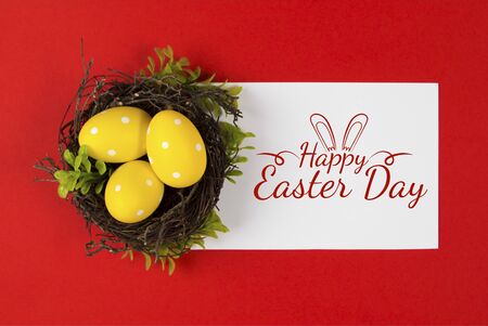 Yellow Easter eggs in a bird's nest on a red background