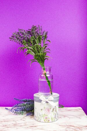 Blank notebook with lavender flowers and floral box on a purple backgroundの写真素材